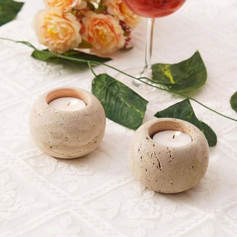 Large Travertine candle holders used for holiday or Christmas table decoration