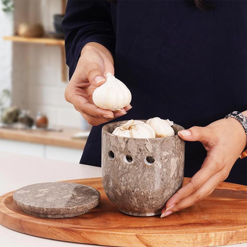 Garlic stored in open oceanic marble garlic container with lid off