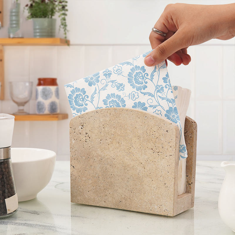 Travertine napkin holder used for tissue napkins on modern kitchen countertop.