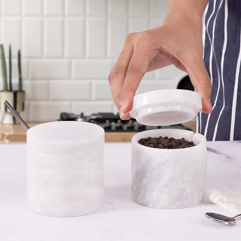 Salt and pepper container set displayed on kitchen countertop