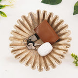 10 inches travertine ruffle bowl holding pens, keys, and coins on an office desk