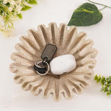 6 inches travertine ruffle bowl holding pens, keys, and coins on an office desk
