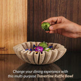 8 inches travertine ruffled bowl holding wrapped candy on modern coffee table