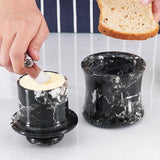 Hand holding black marble butter keeper crock for soft spreadable butter