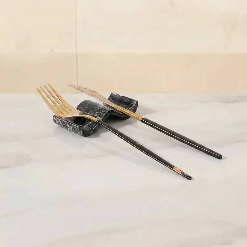 Black marble chopstick rests set of 2 used as knife rest and fork rest with gold cutlery on white marble dining table — Speshstones