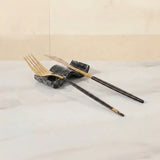 Black marble chopstick rests set of 2 used as knife rest and fork rest with gold cutlery on white marble dining table — Speshstones