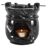 Black marble oil burner and wax warmer for home fragrance with white background