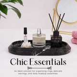 Black marble oval tray used for organizing perfume, makeup, and daily essentials on bathroom countertop
