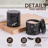Close-up of black marble salt and pepper container showing easy-to-clean natural stone and stainless steel spoon
