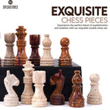 Close-up of hand-carved travertine marble chess pieces with extra queens in travertine and red marble