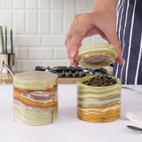 green salt and pepper container set displayed on kitchen countertop