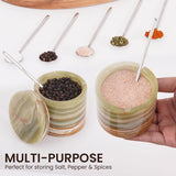 green salt and pepper containers filled with various spices like chili, herbs, and rock salt