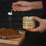 green marble salt cellar used for seasoning on kitchen countertop