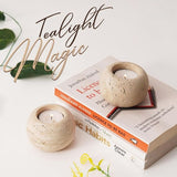 Close-up of large travertine tea light candle holder showing natural stone texture