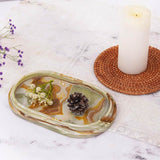 Decorative marble tray in green used as a candle holder or coffee table centerpiece