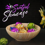 Travertine marble serving bowl used at a party buffet table with snacks and fruits.