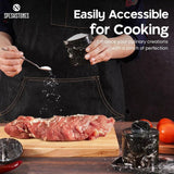 Hand using black marble salt cellar for seasoning meat – ideal for cooking and easy access to salt