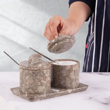Elegant marble salt and sugar containers in oceanic displayed on kitchen countertop