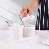 Elegant marble salt and sugar containers in white displayed on kitchen countertop