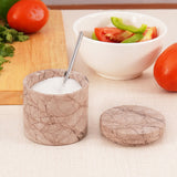 marinara marble salt cellar with spoon placed between fresh vegetables on cutting board