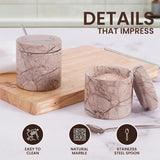 Close-up of marinara marble salt and pepper container showing easy-to-clean natural stone and stainless steel spoon