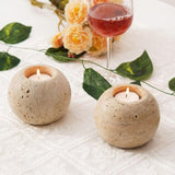 Medium Travertine candle holders used for holiday or Christmas table decoration