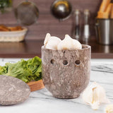 oceanic marble travertine garlic and onion holder placed with fresh vegetables on kitchen counter