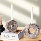 Oceanic marble candle holders placed next to the book for cozy decor styling