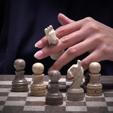 Oceanic marble chess pieces on handcrafted travertine chess board, 12-inch game set