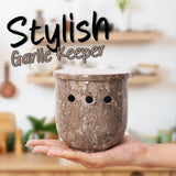 oceanic marble garlic holder with garlic bulbs on countertop