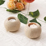 Small Travertine candle holders used for holiday or Christmas table decoration