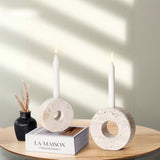 Travertine Stone candle holders placed next to the book for cozy decor styling