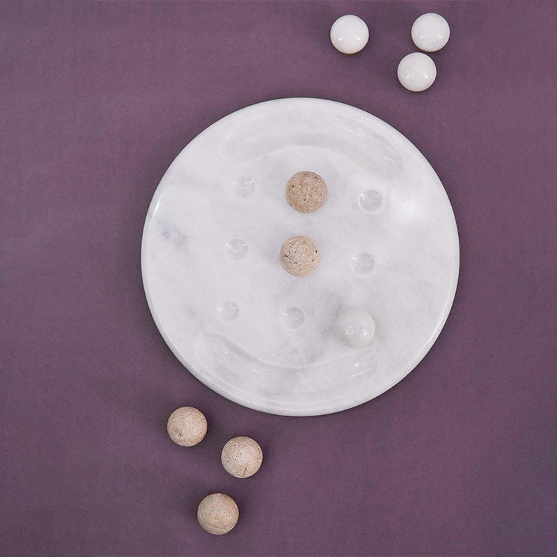 Overhead view of Travertine Marble Tic Tac Toe set with X and O pieces arranged in play, minimalistic flatlay on neutral tabletop – Speshstones