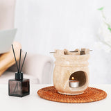 Travertine marble oil burner used as a decorative centerpiece on a living room table