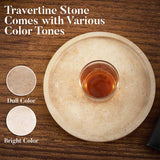 Round travertine tray showing bright and dull natural color tone variations with glass placed on top