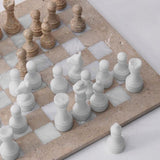 Top view of 15 inch travertine and white marble chess board with handcrafted pieces