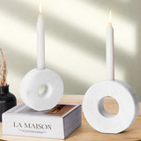 White marble candle holders placed next to the book for cozy decor styling