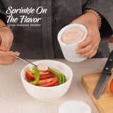 white marble salt cellar used for seasoning on kitchen countertop